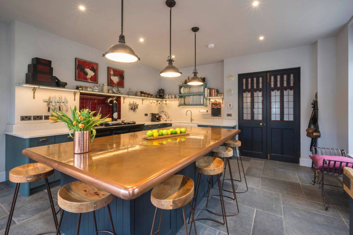 Custom copper kitchen island countertop sparkles in this kitchen