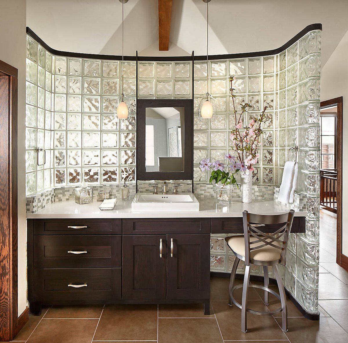 Custom wall with glass blocks seperates the bathroom from the bedroom in this master suite