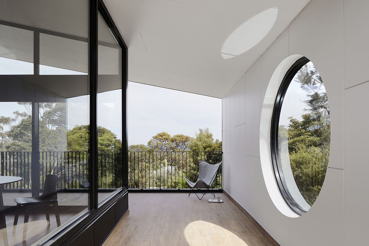 Custom windows around teh living area offer a view of the bushlands