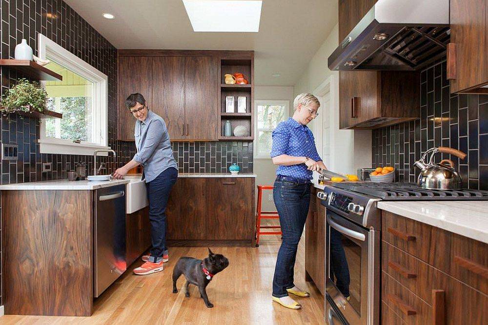 Deep brown Vertical tiles on the wall are elegantly combined with dark wooden cabinets in this kitchen