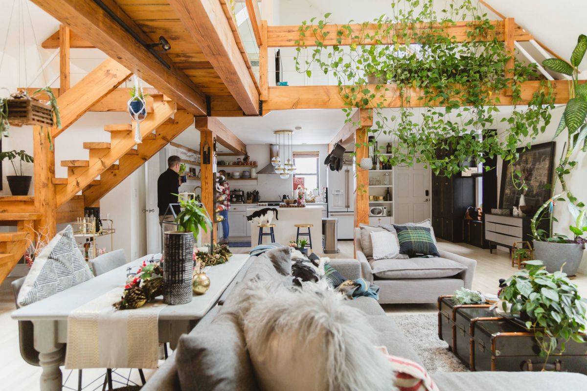 Eclectic-living-room-of-Chicago-home-with-wood-and-white-color-scheme-and-greenery-indoors-58464