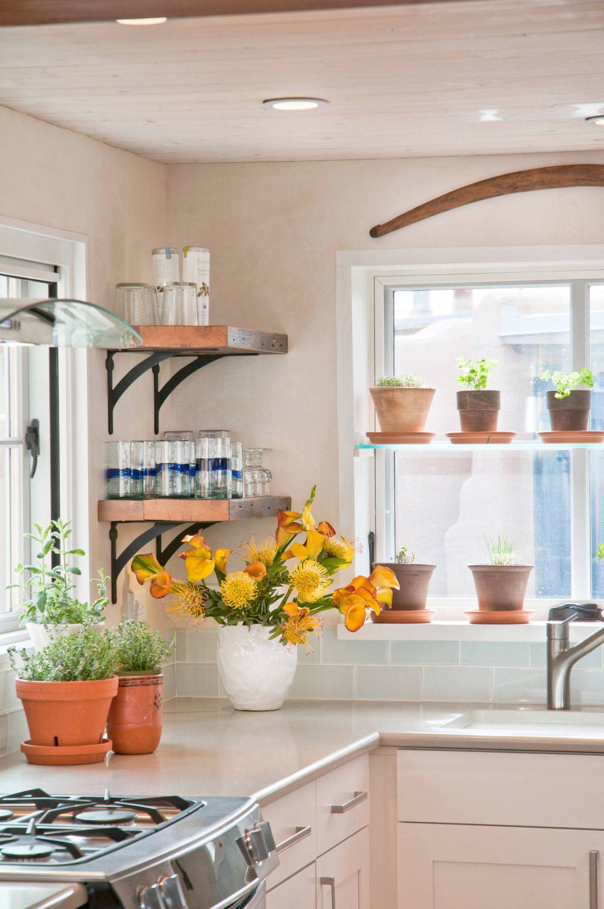 Few things add freshness and cheer to a kitchen like flowering plants and a herb garden