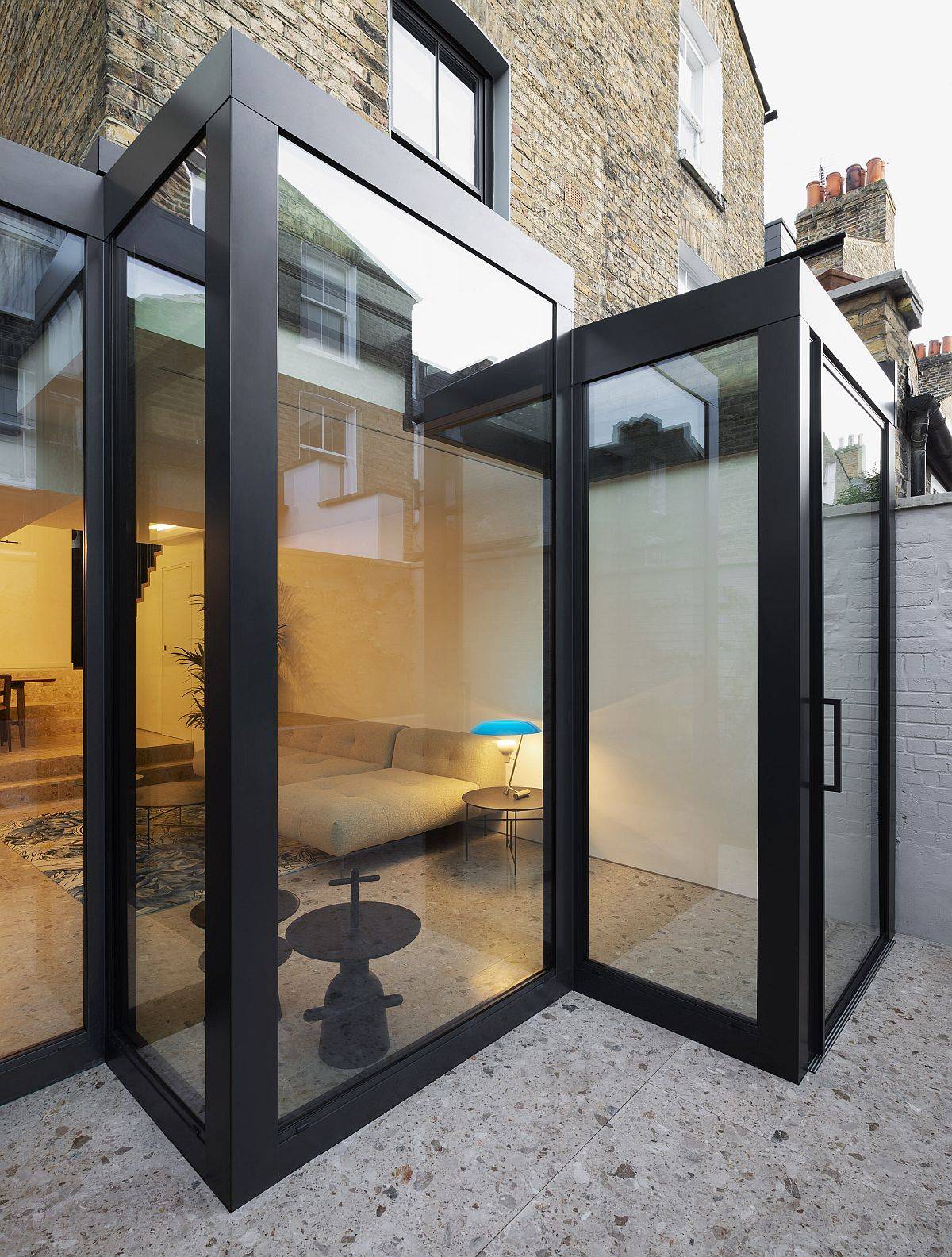 Gorgeous interlocking geometric glass volumes extend the classic Victorian terrace home in South London