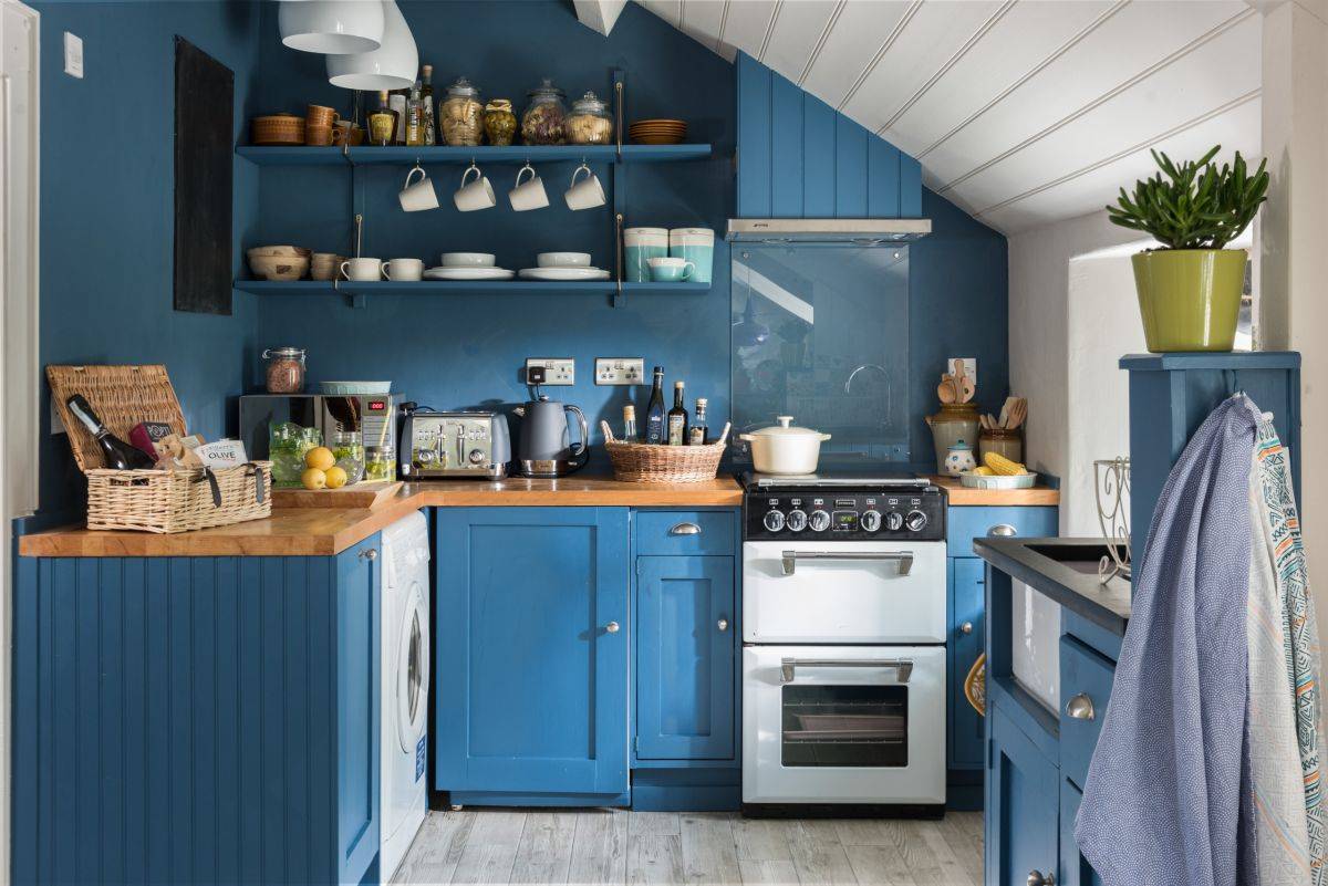 Love the balance between use of color and natural light in this small eclectic kitchen