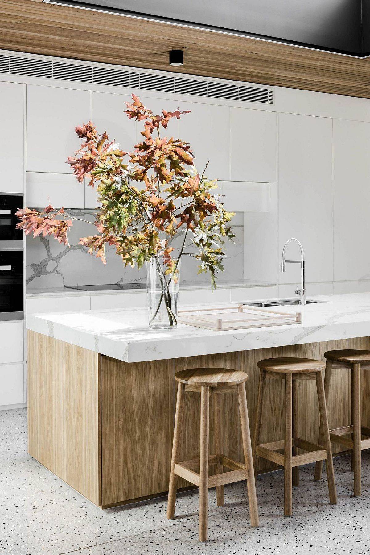 Marble brings a touch of class and sophistication to the wood and white kitchen