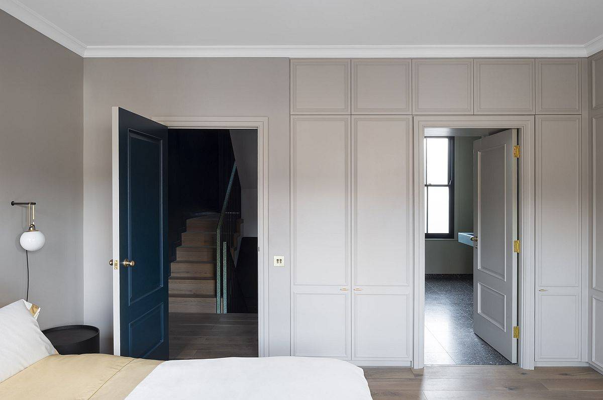 Master suite of the home in brown and white with blue doors