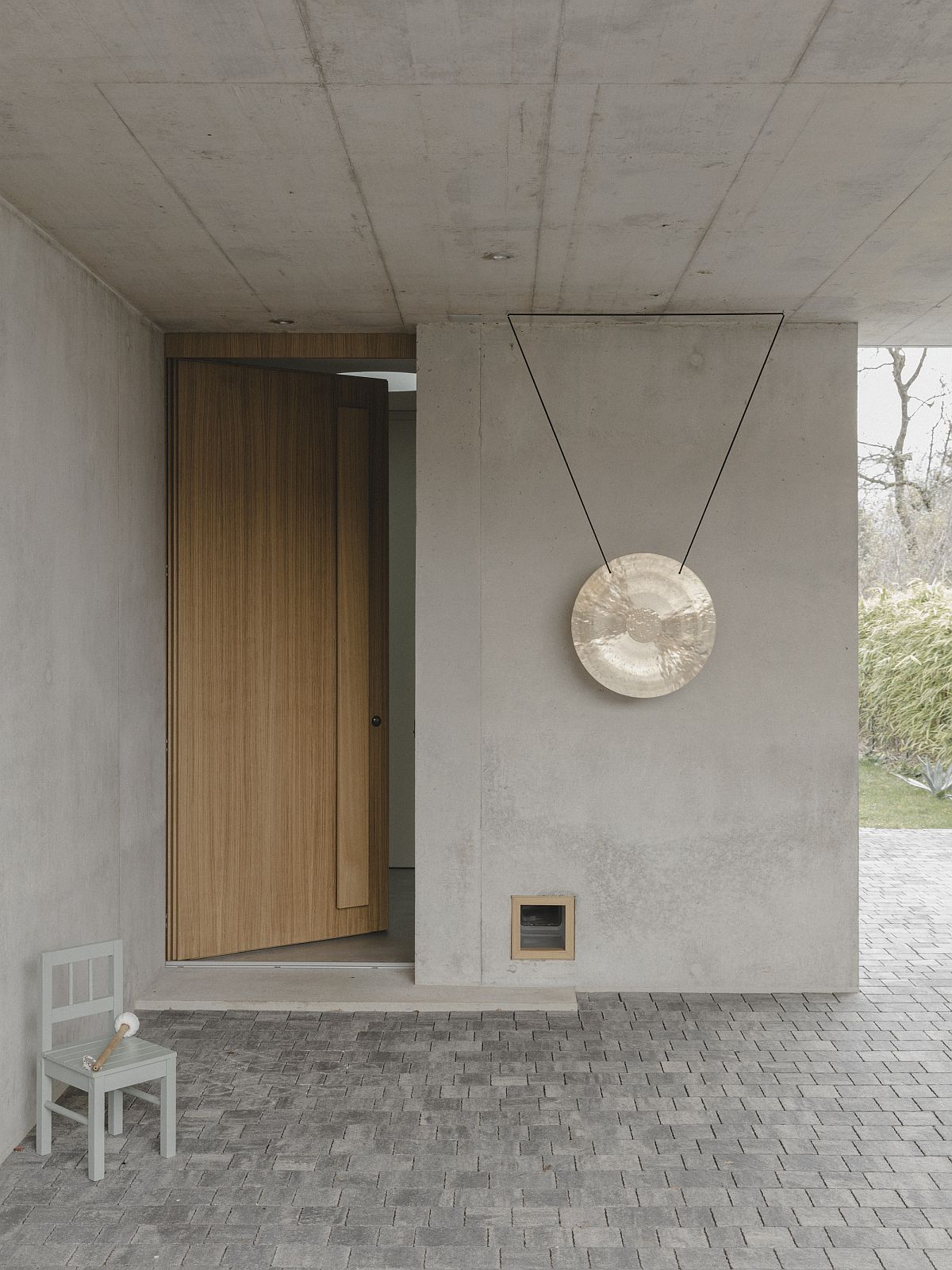 Modern wood and concrete entry with a protected entryway