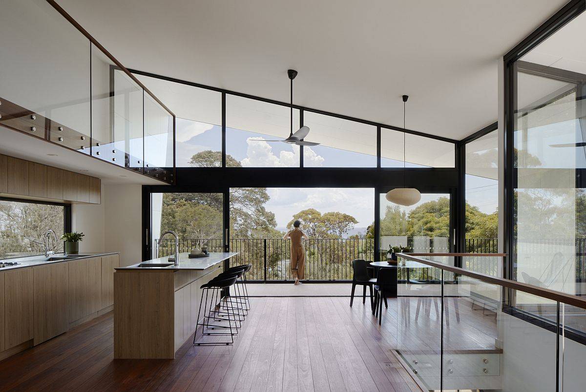 Open-plan living, kitchen and dining area on the upper level with double-height ceiling