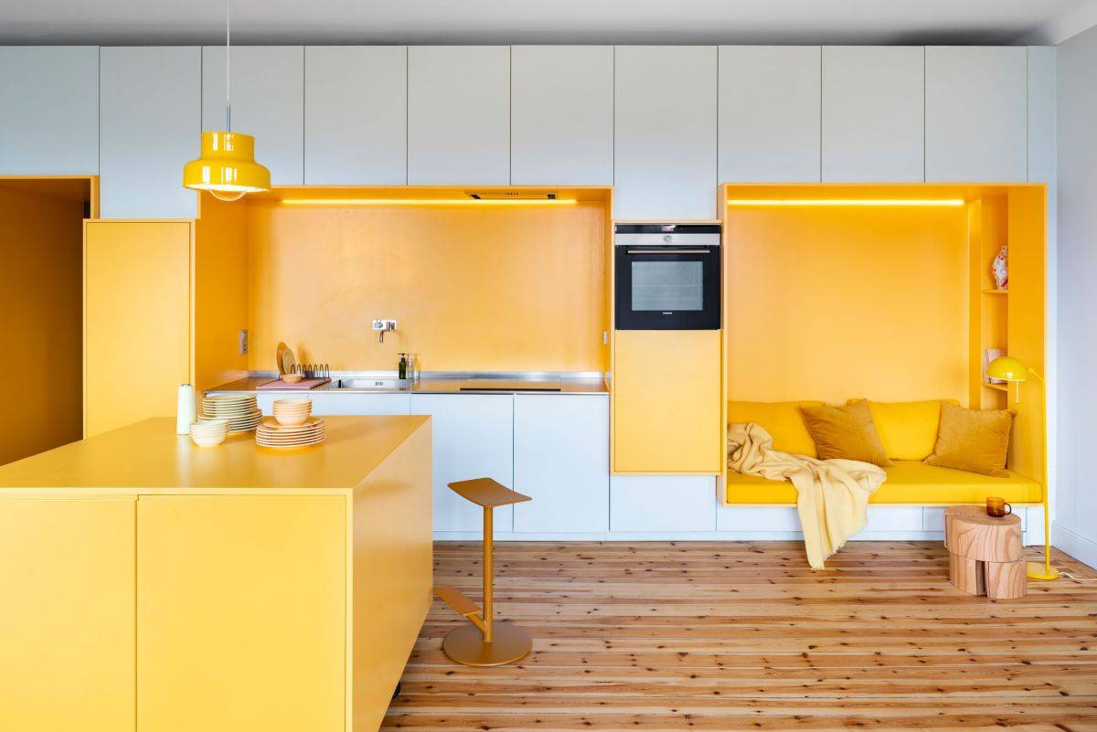 Polished contemporary kitchen in white and yellow with a gorgeous built-in niche