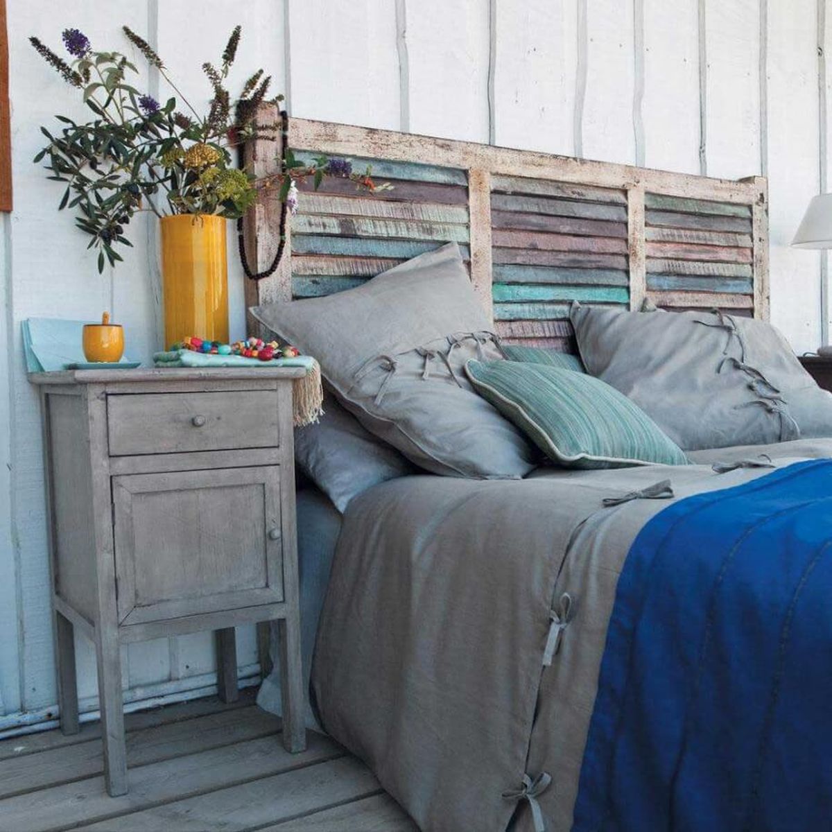 Repurposed window shutters turned into a lovely DIY headboard