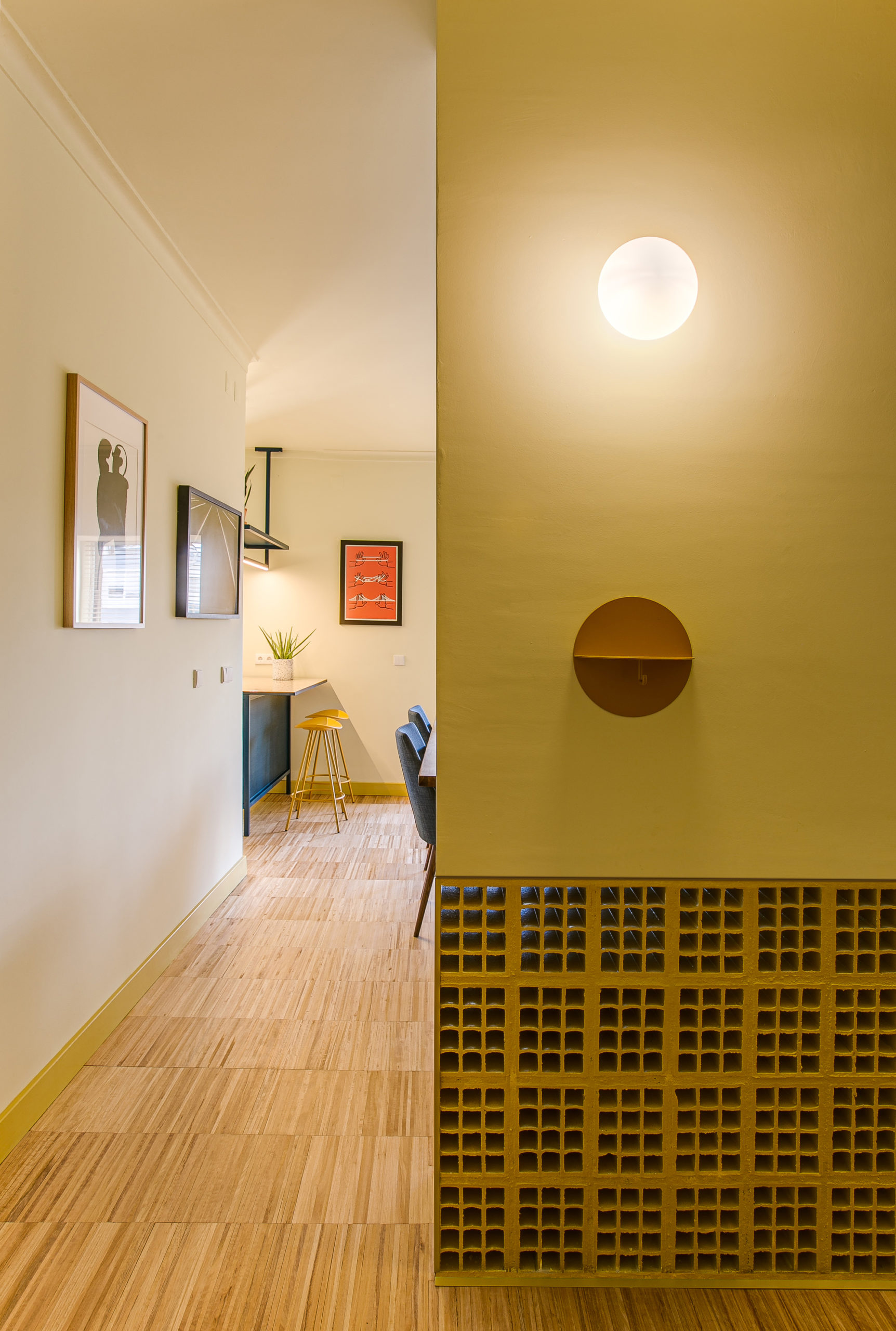 Revamped interior of old apartment in Portugal with wooden floors and bright yellow walls