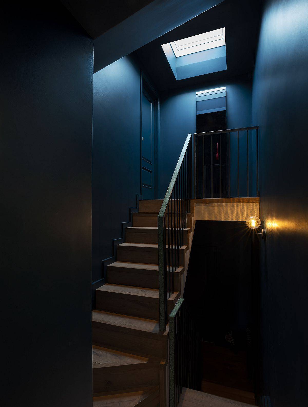 Revamped staircase with bespoke terrazzo handrail connects different levels of the home