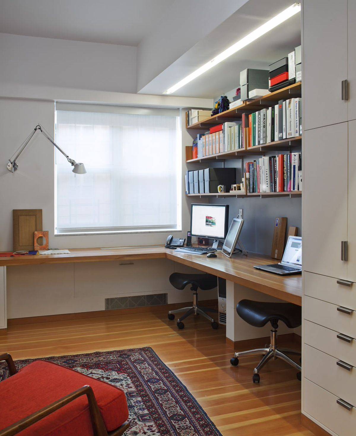Smart New York home office with a built-in desk that offers ample workspace