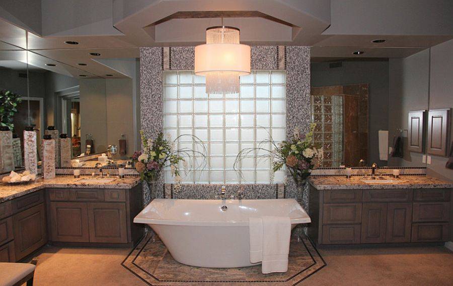 Spacious traditional bathroom in wood and gray with glass block backdrop