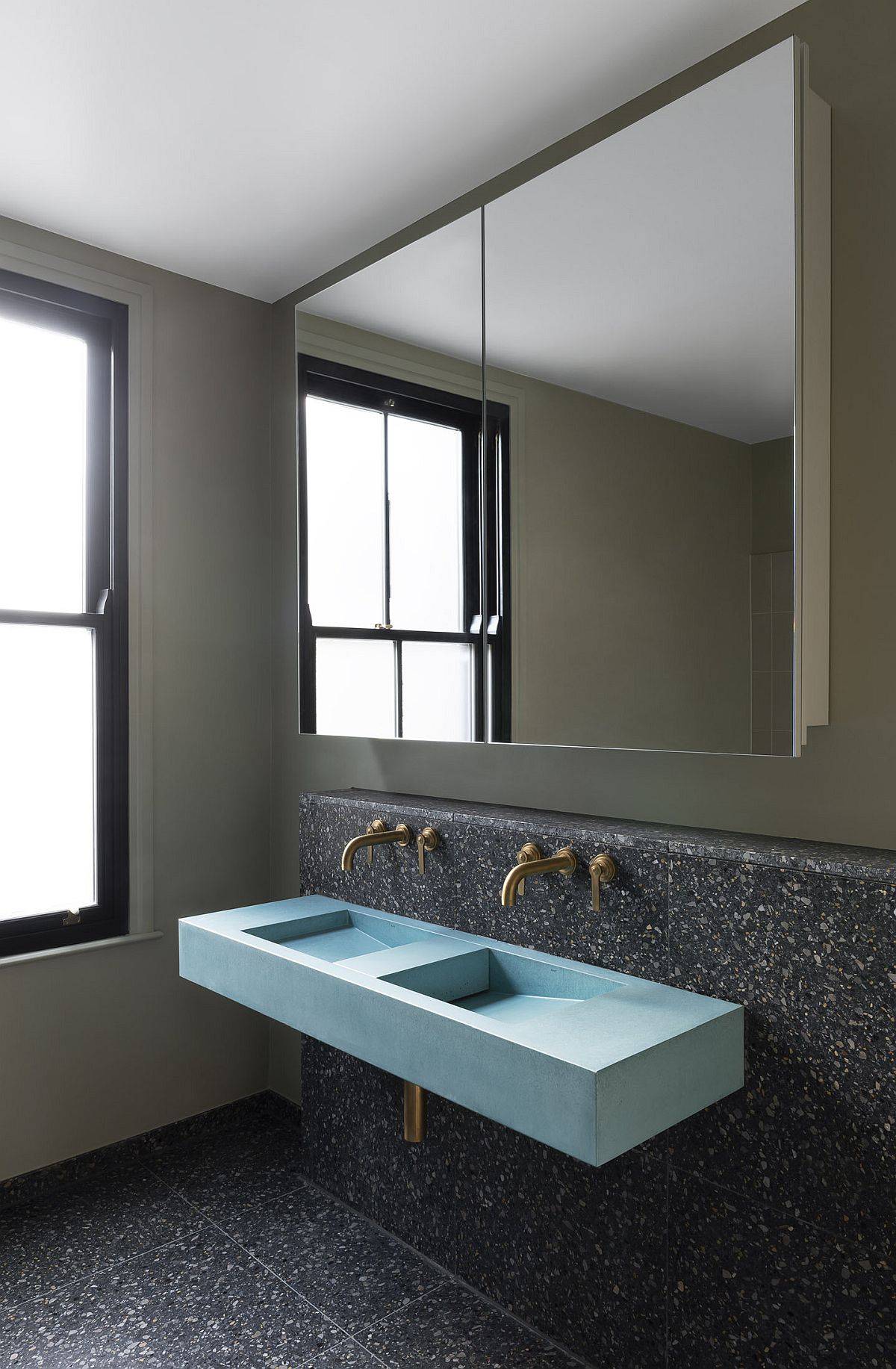 Terrazzo floor and tiles in the bathroom continue the theme of the home renovation