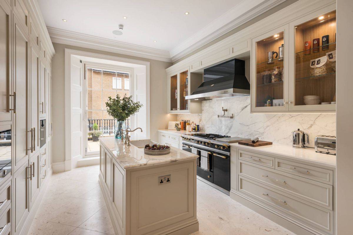 Traditional kitchen with classic English look and a marble backsplash