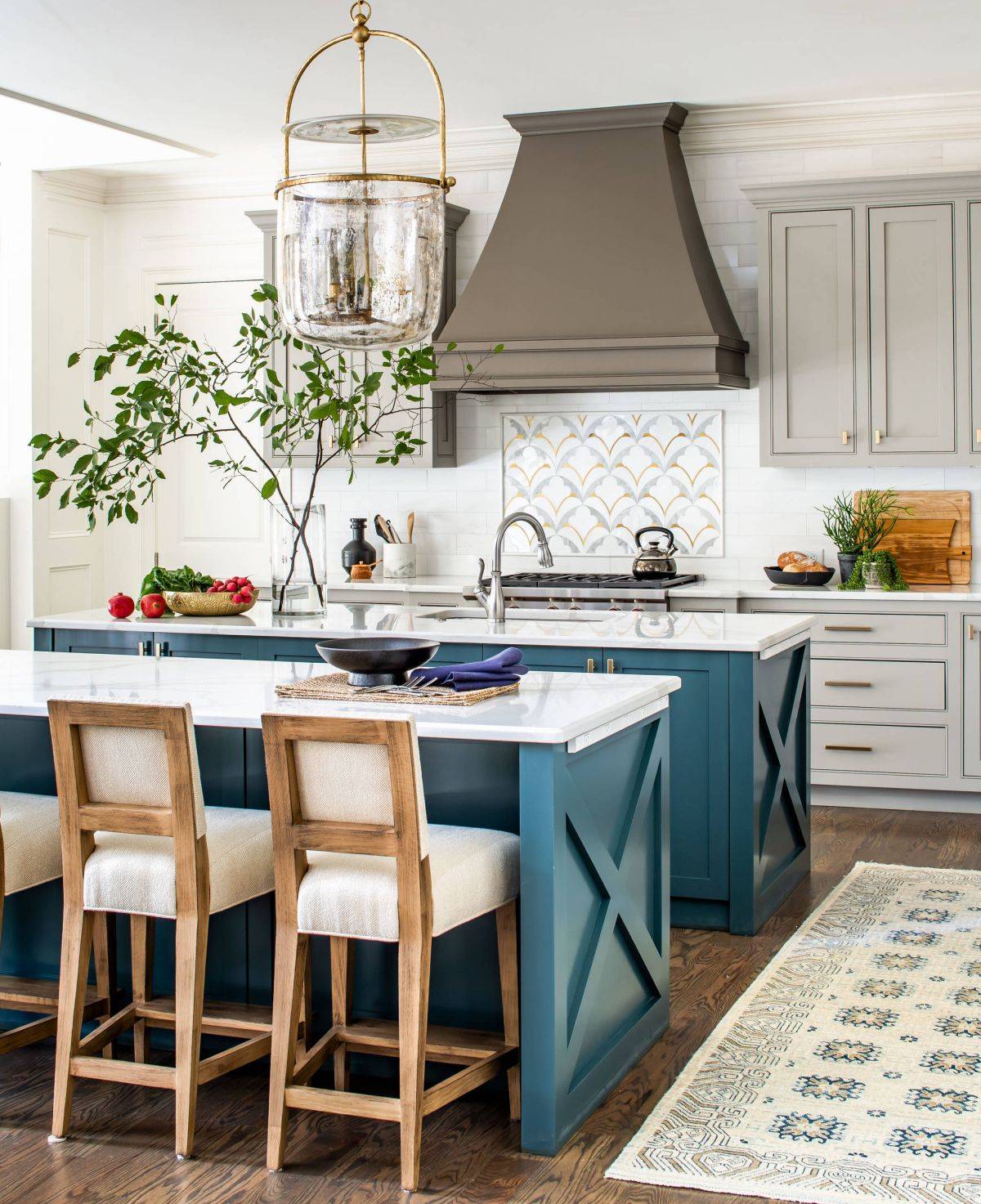 Twin kitchen islands in blue with white countertops are just perfect for this modern farmhouse style kitchen
