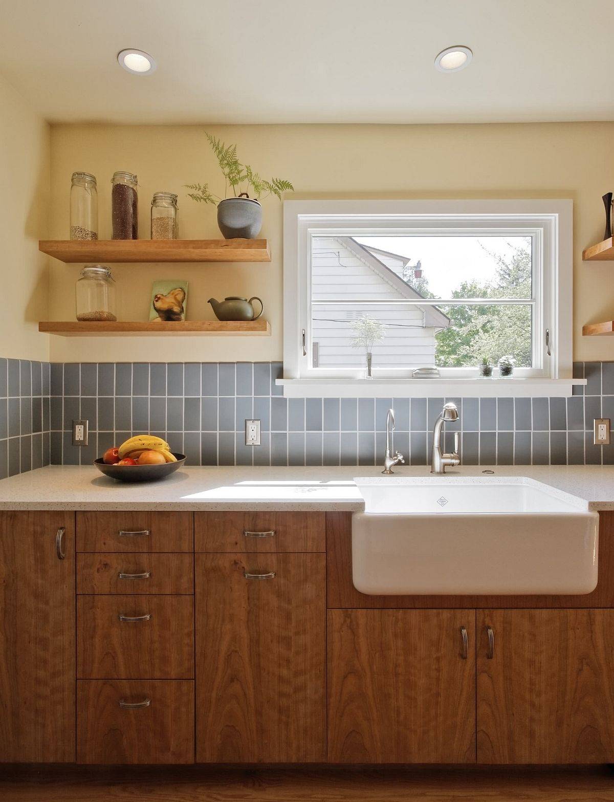 Understaed and classy use of light blue subway tile in a vertical arrangement for the kitchen backsplash