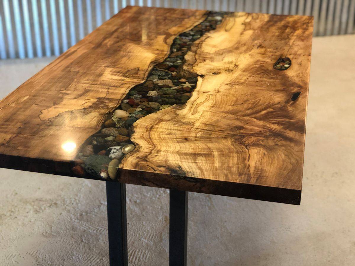 Unique Live edge Maple dining table filled with shells and rock and covered with epoxy resin