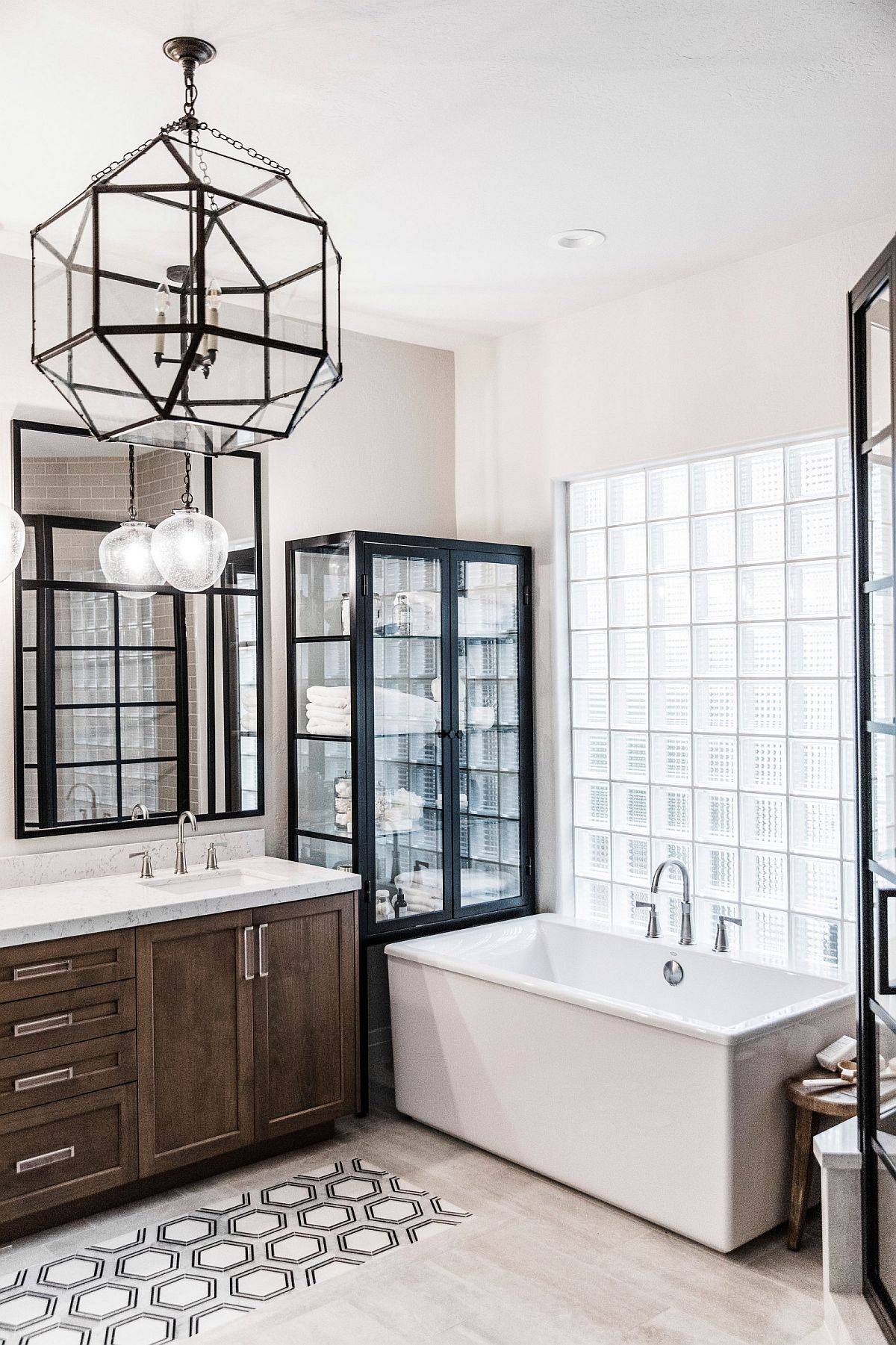 Wall of glass blocks next to the bathtub brings light into this contemprary bathroom