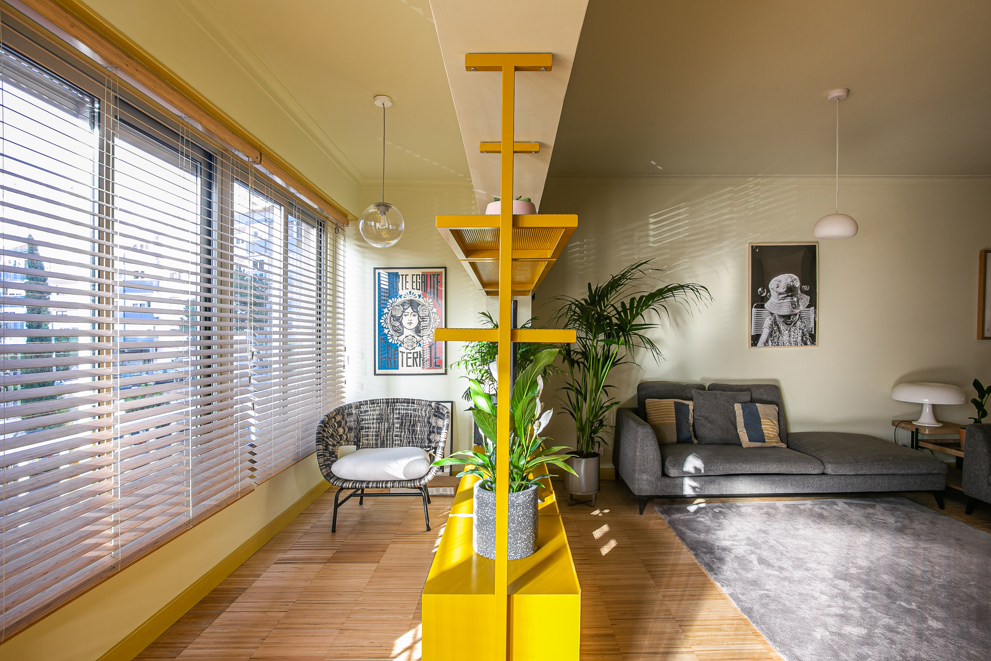 Yellow partition turns a part of the living room into the sunroom
