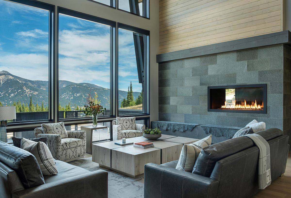 Amazing mountain views enliven this magical rustic living room in glass and gray!