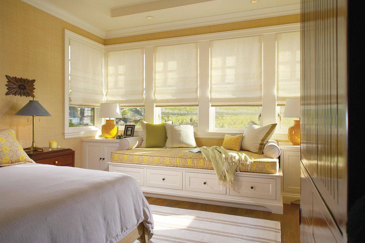 Lovely modern bedroom with grasscloth walls in yellow along with a window seat in matching hue