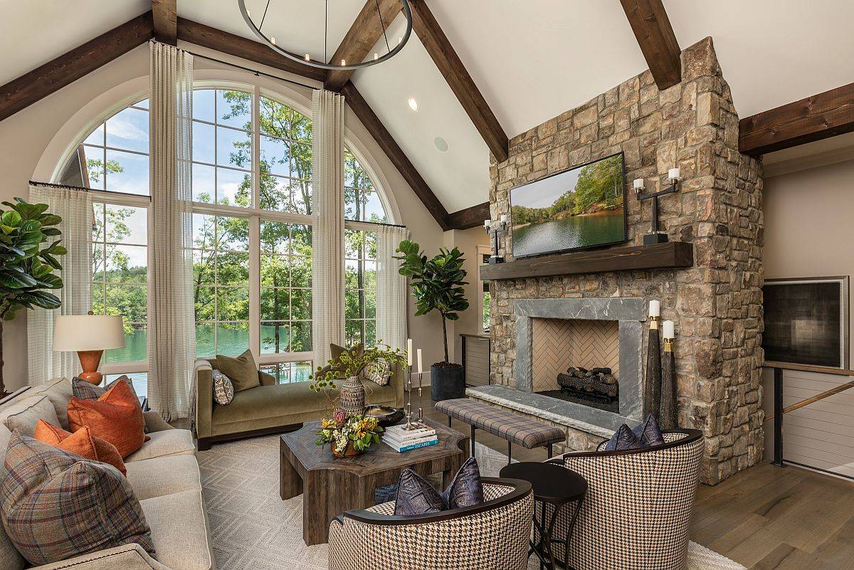 Scenery outside makes the biggest impact in this small modern-rustic living space in neutral hues with stone fireplace