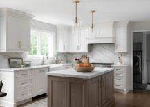 Stone-slab-backsplash-with-matching-counters-and-island-tops-creates-a-minimal-look-in-the-dapur-17179-217x155