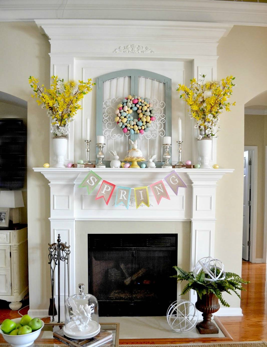 The Easter egg wreath anchors the mantel (from Adventures in Decorating)