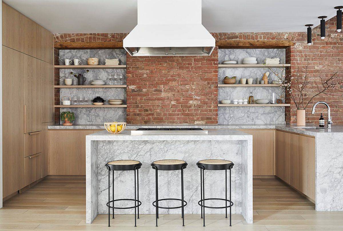 Brick and stone backsplash in the kitchen coupled with sleek floating shelves and wooden cabinets