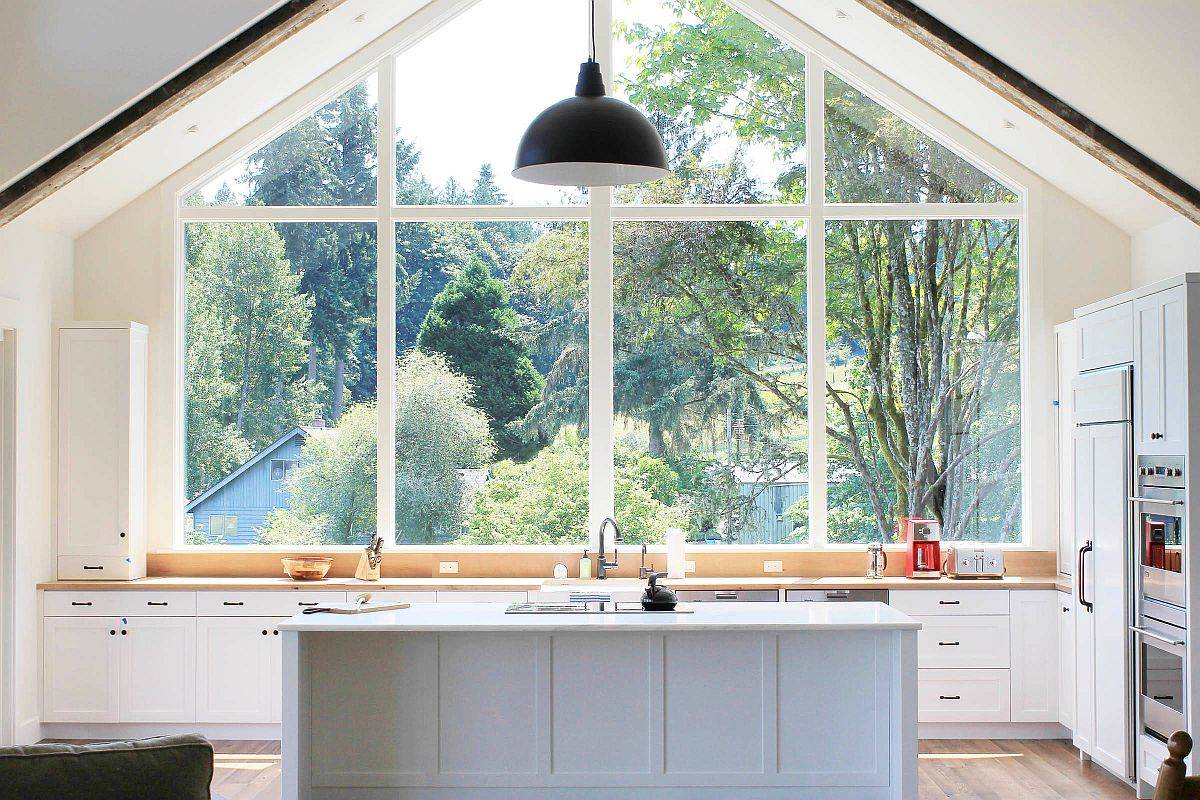 Farmhouse style kitchen with large window above the counter that brings nature indoors