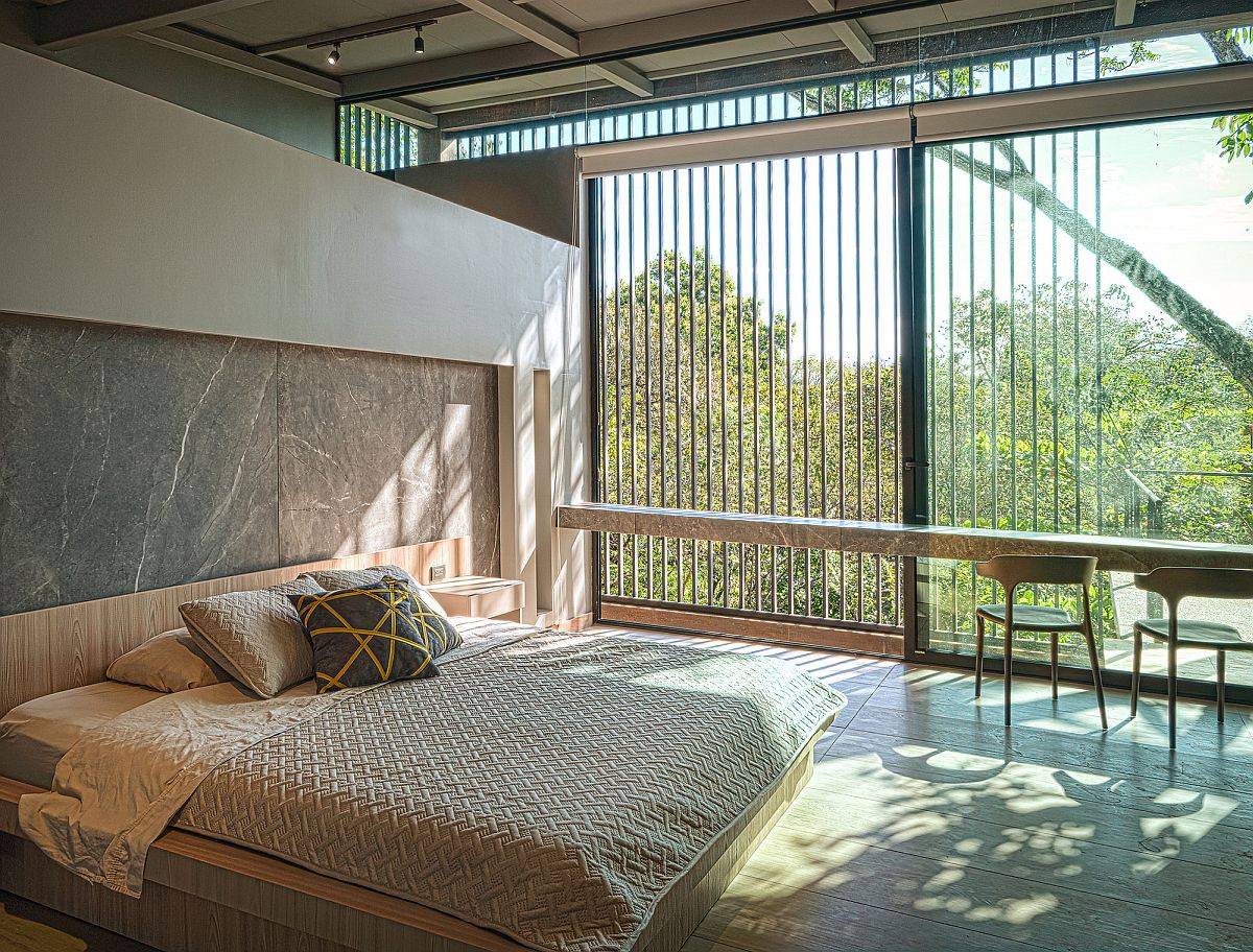 Filtered light and lovely views fashion this fabulous modern bedroom