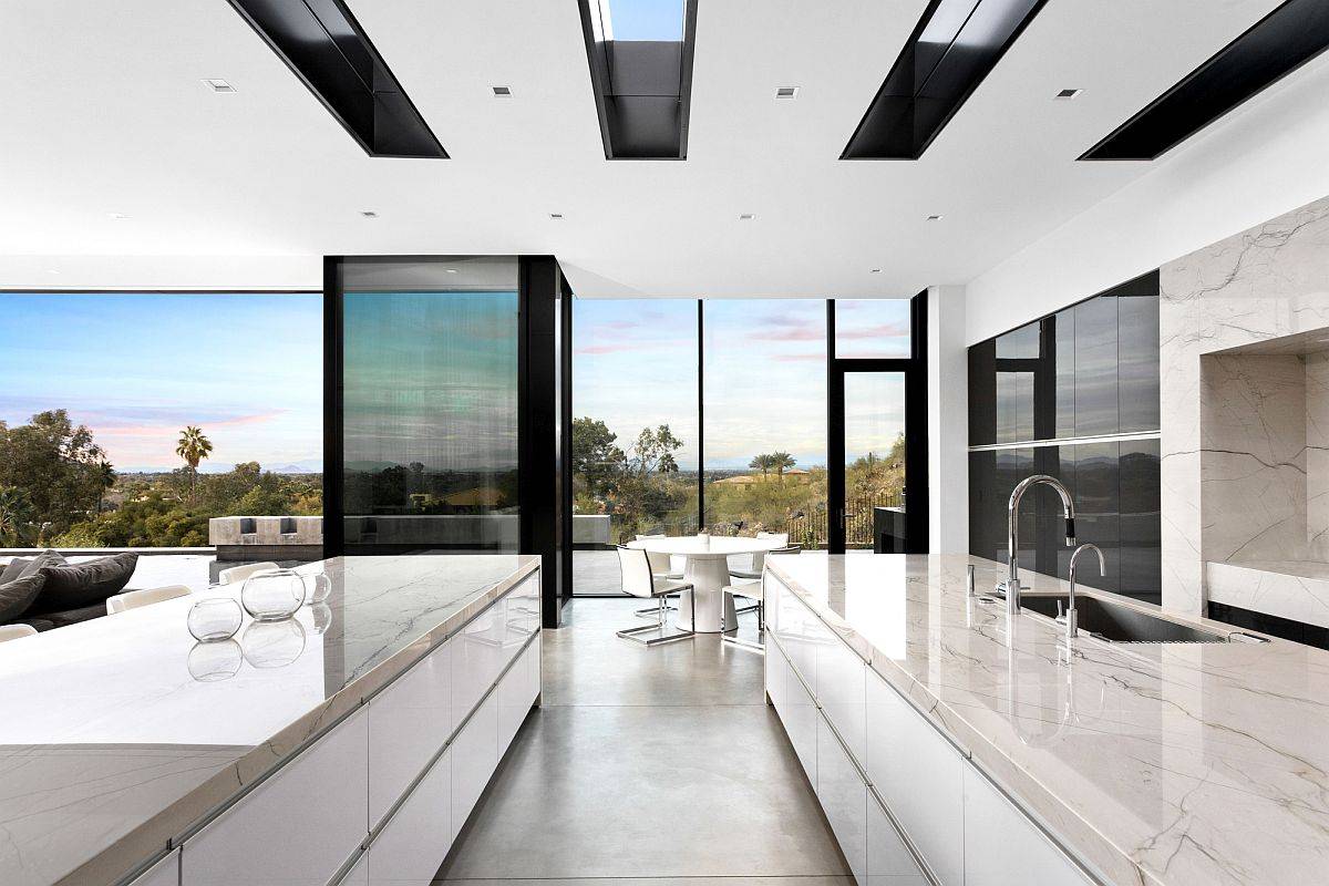 Gorgeous kitchen and dining area in white with clerestory windows and amazing views of the landscape