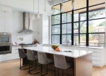 Large-double-height-kitchen-in-white-with-wood-flooring-and-large-window-above-the-counter-80076-217x155
