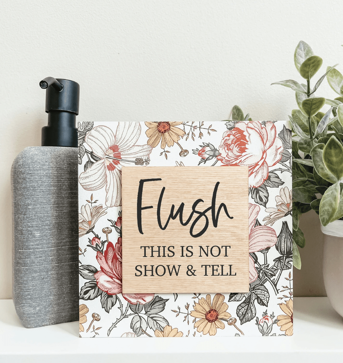 flush show and tell sign on floral background soap dispenser greenery