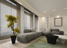 modern living room grey low couch and black blinds