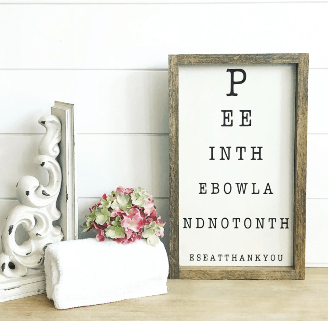 pee in the bowl eye chart funny bathroom sign on shiplap background with rustic corbel and towel with flower