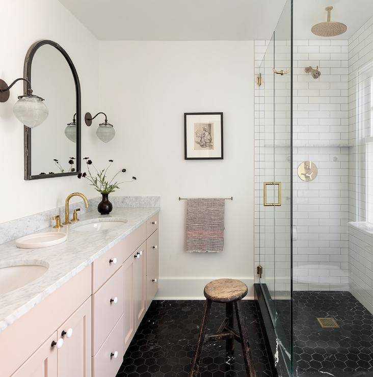 pink vanity black tile mirror gold fixtures walk in shower bathroom