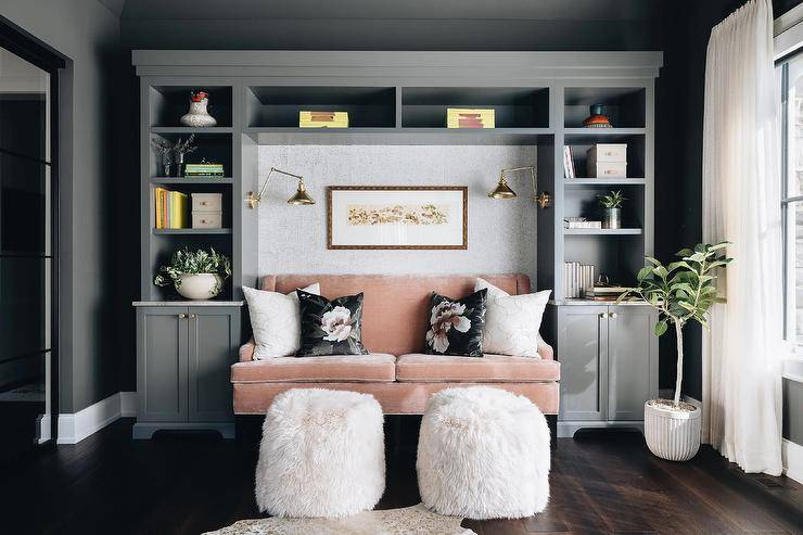 pink dark grey room bookshelf couch white furry pouf