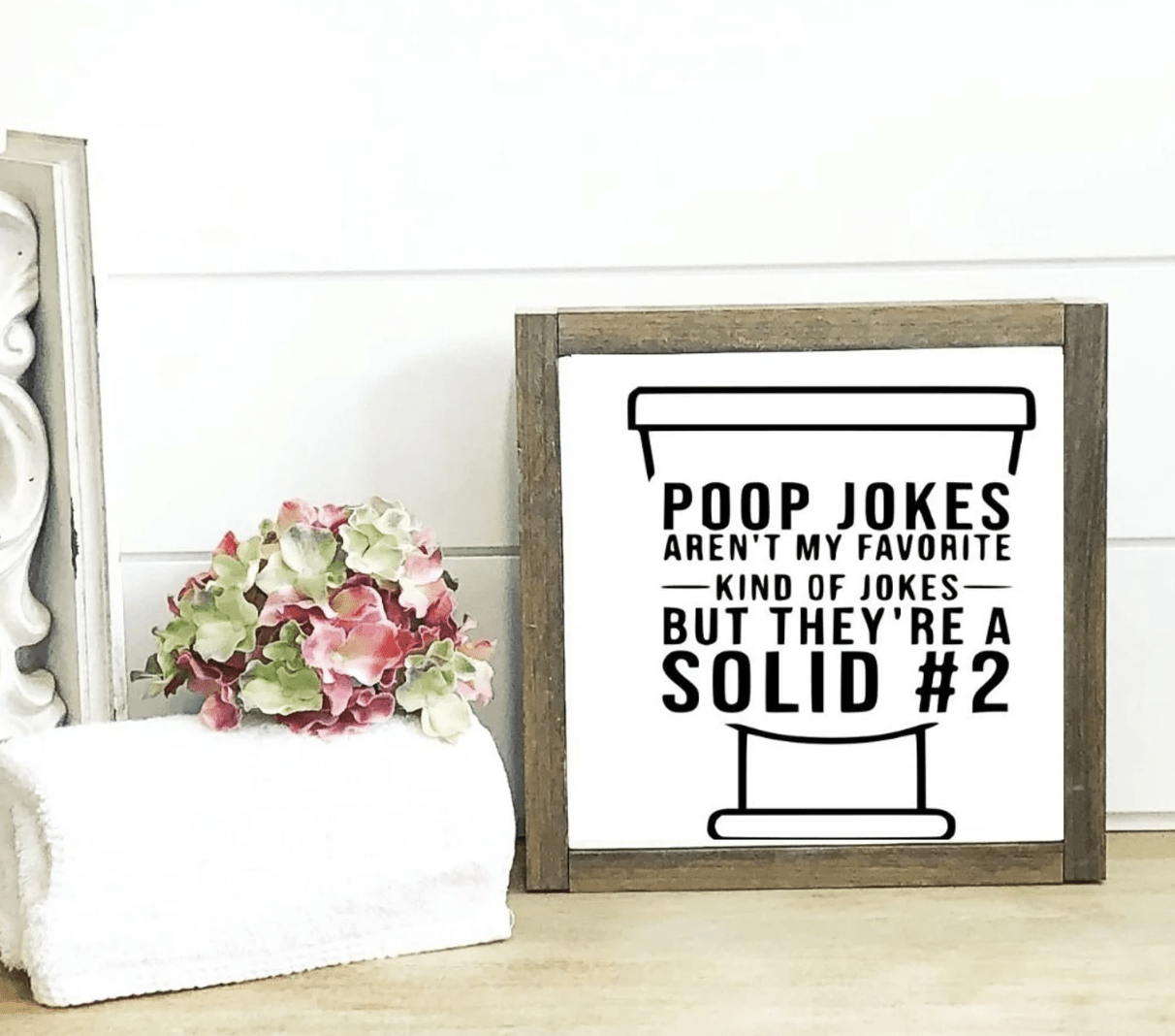 poop jokes rustic wood frame bathroom sign white shiplap background flower towel