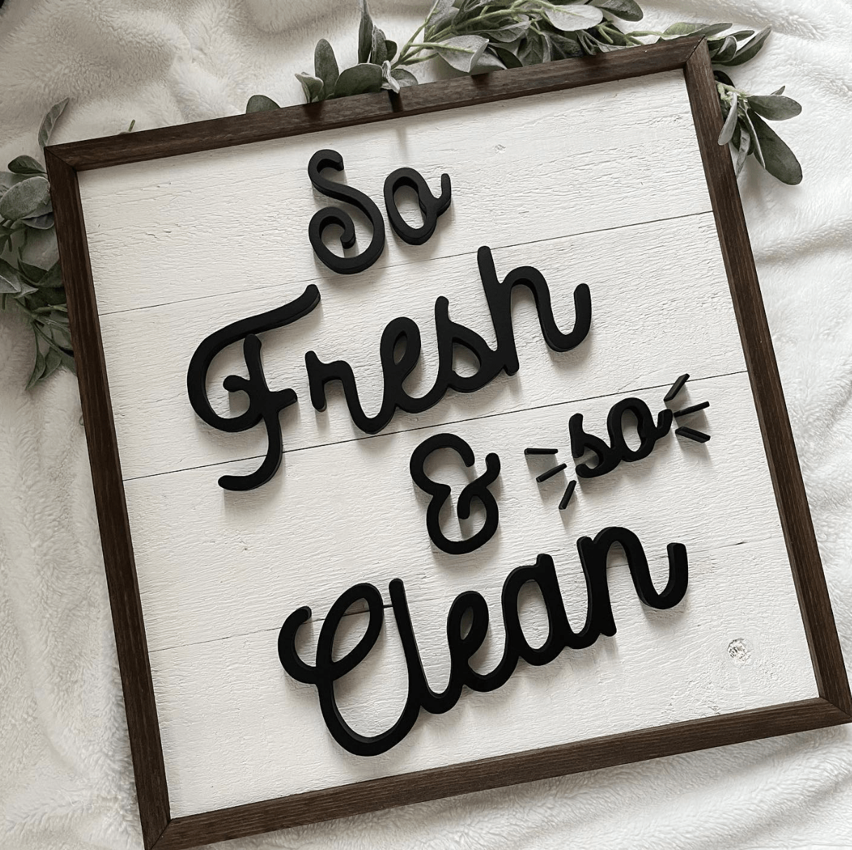 so fresh clean wood rustic sign on soft towel background with greenery