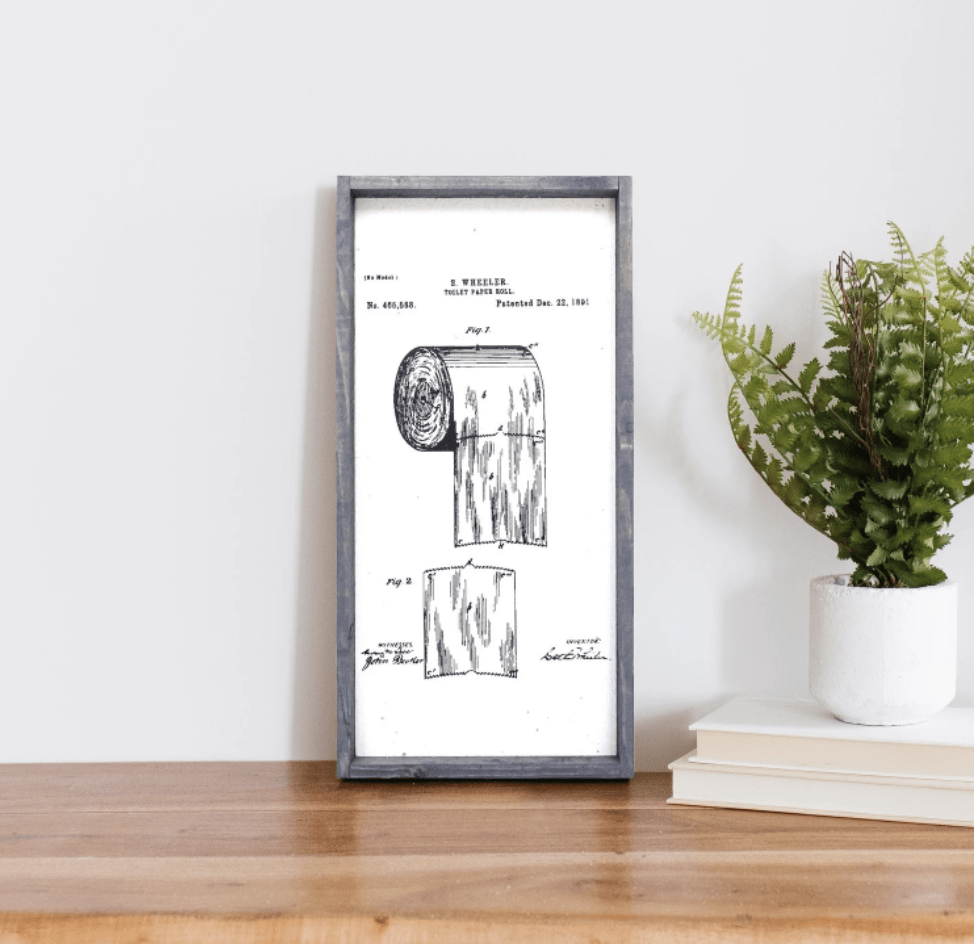 toilet paper patent sign wood frame grey white background greenery