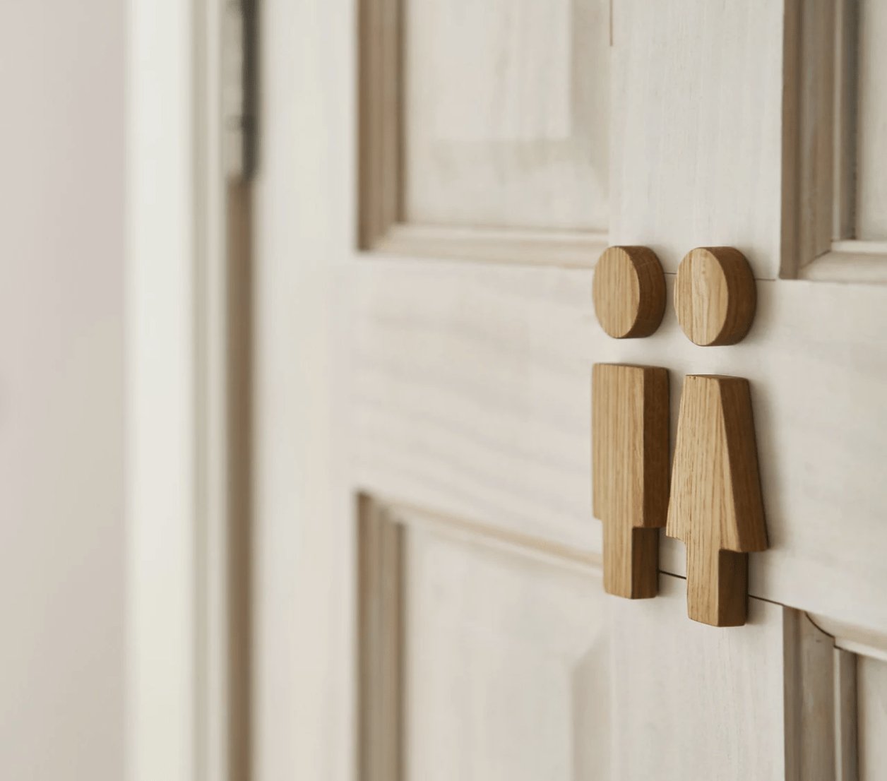 wood people on a bathroom door close up