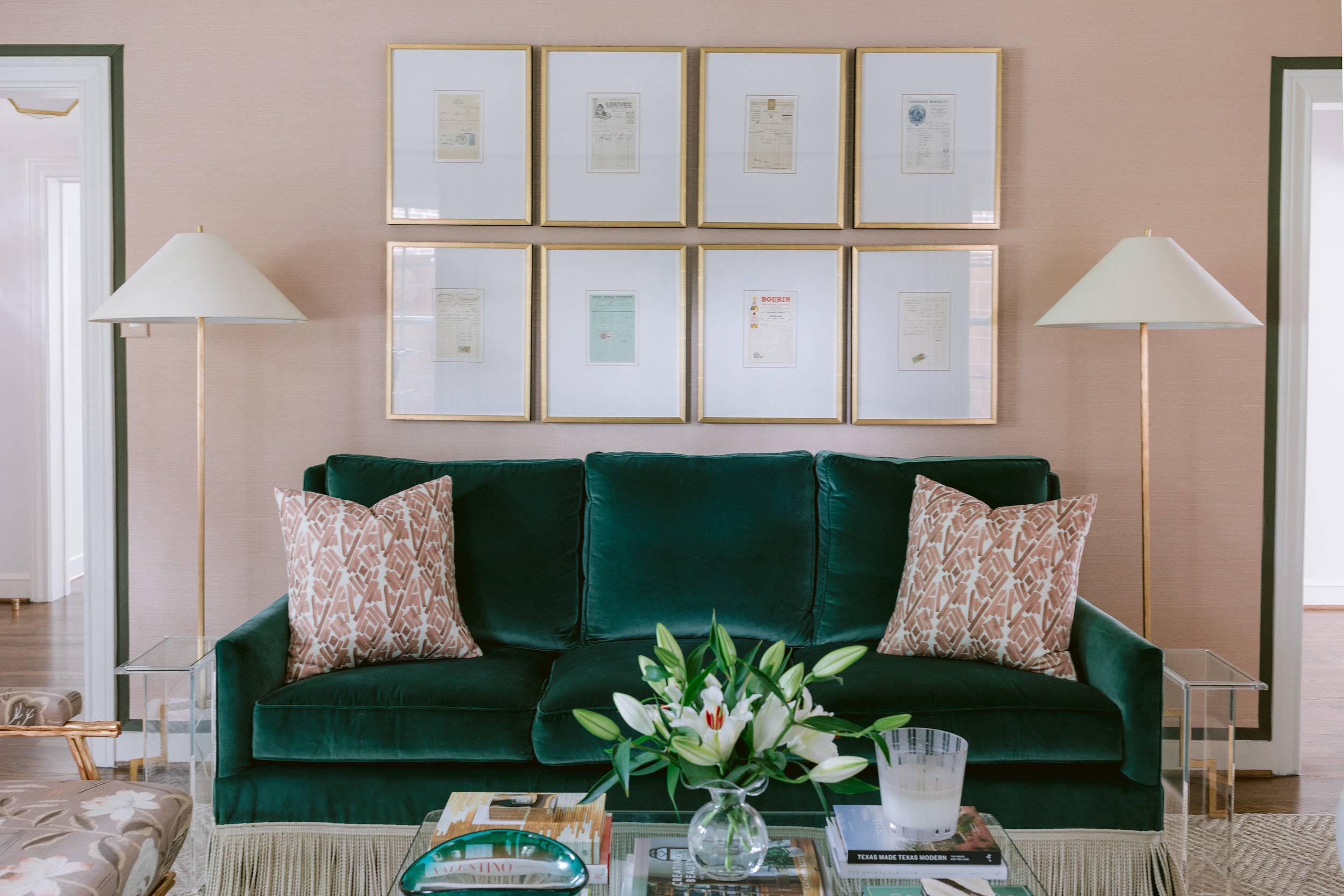 living room with pink and emerald couch and gallery wall art pillows