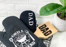 black oven mitts dad father's day gift idea wood bbq scraper white brick background plant wire basket