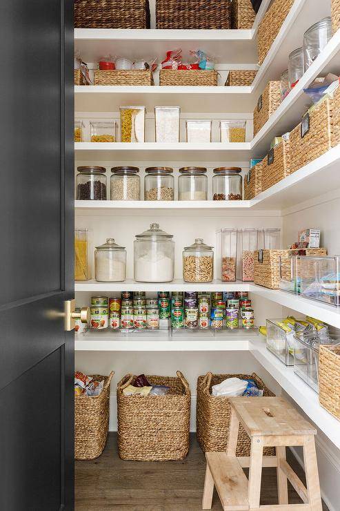 pantry with door open black baskets food storage class jar containers