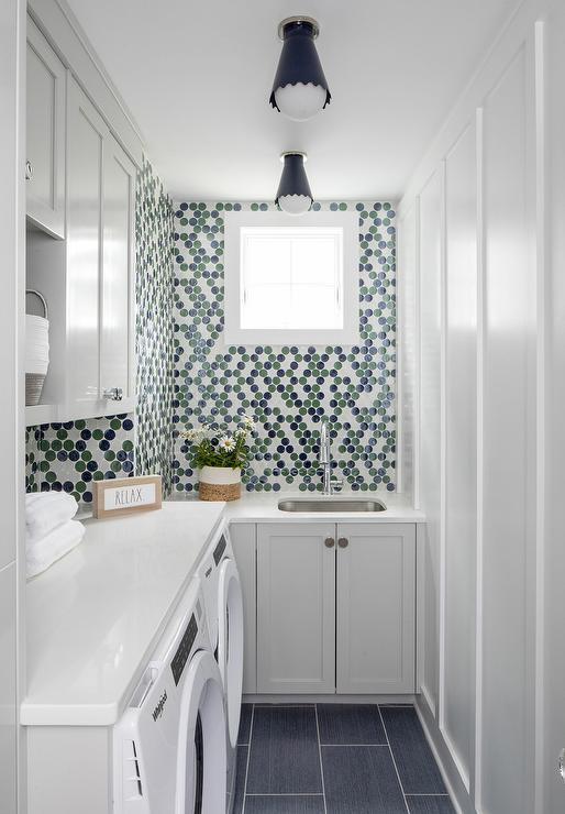 circle backsplash green and blue flush mount ceiling light white cabinetry sink white countertop