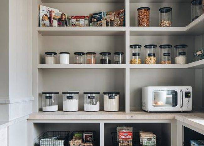 clear jars black lids light gray open pantry cookbooks wire black baskets microwave