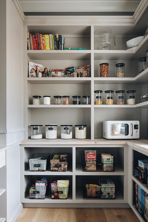 clear jars black lids light gray open pantry cookbooks wire black baskets microwave